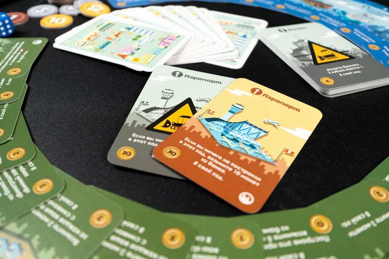 A top-down view of Machi Koro game components, featuring landmark cards.